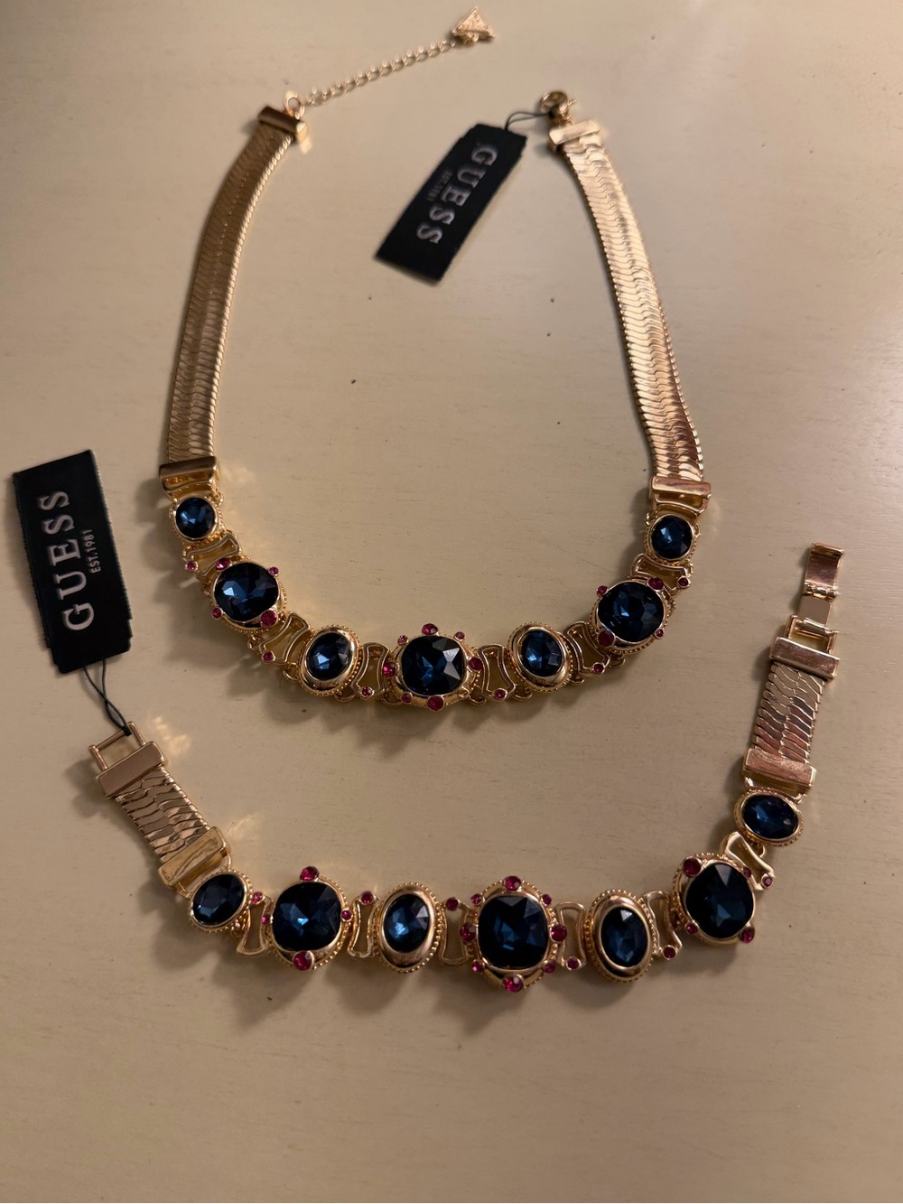 NWT Guess statement necklace & bracelet w/blue “jewels”. Both adjustable.